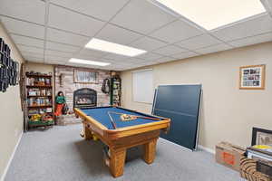 Game room with carpet floors, a fireplace, a paneled ceiling, pool table, and baseboards