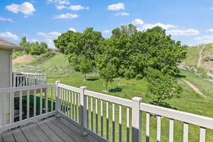 Wooden terrace featuring a lawn