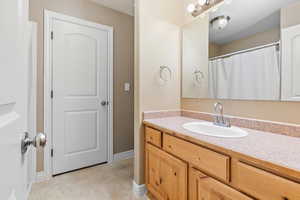 Full bathroom featuring baseboards and vanity