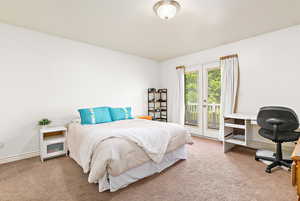Bedroom with carpet flooring, access to exterior, an office area, and baseboards
