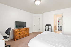 Bedroom featuring light colored carpet and baseboards