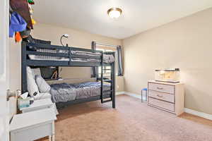 Carpeted bedroom featuring baseboards