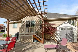 View of patio featuring outdoor dining area, a storage shed, an outbuilding, and a pergola