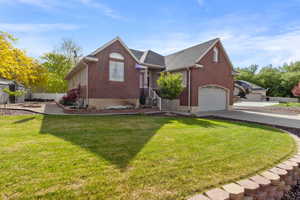 View of front facade featuring brick siding, a garage, concrete driveway, and roof with shingles