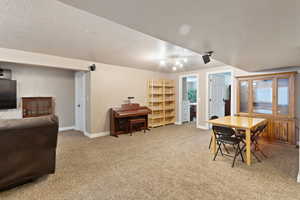 Dining space featuring baseboards, carpet floors, and a textured ceiling