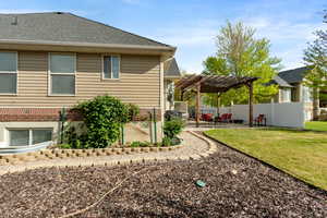 Back of house with a pergola, a patio, and roof with shingles