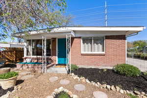 View of front of property with brick siding and fence