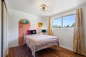 Bedroom with baseboards and hardwood / wood-style flooring