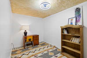 Office area featuring baseboards and wooden ceiling