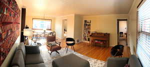 Living area featuring wood finished floors, ornamental molding, and baseboards