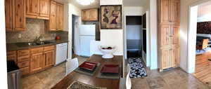 Kitchen featuring white appliances, a sink, backsplash, and baseboards
