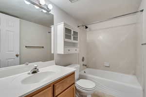 Bathroom featuring toilet, bathtub / shower combination, and vanity