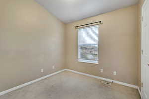 Unfurnished room featuring carpet floors and baseboards