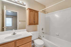 Full bath with vanity, shower / bath combination, and toilet