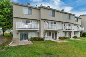 Rear view of property with stucco siding and a patio area