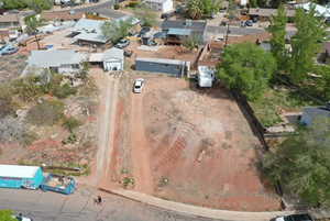 Aerial view of property and surrounding area with nearby suburban area