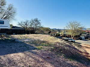 View of yard featuring fence, a residential view, and a mountain view