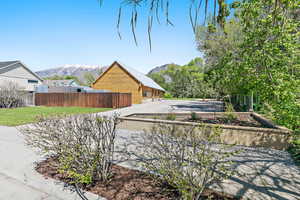 Street view of the home featuring a charming flower bed