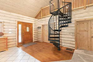 Tiled foyer with spiral staircase leading to the loft