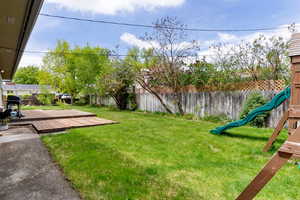 View of yard featuring a deck and a playground