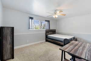 Bedroom featuring carpet, baseboards, and a ceiling fan