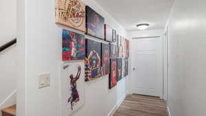 Corridor featuring wood finished floors and baseboards