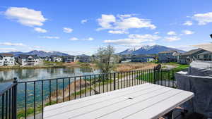 Deck featuring a residential view and a water and mountain view