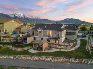 View of front facade with a gazebo, a mountain view, stucco siding, a residential view, and roof with shingles