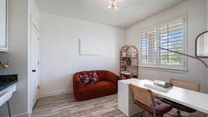 Office with light wood finished floors and baseboards