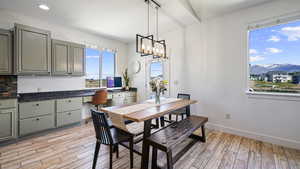 Dining area featuring light wood-type flooring, baseboards, a chandelier, and recessed lighting
