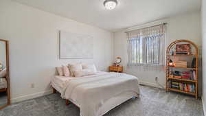 Carpeted bedroom featuring baseboards