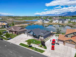 Aerial perspective of suburban area with a water and mountain view