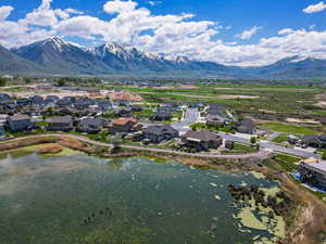 Aerial perspective of suburban area with a water and mountain view