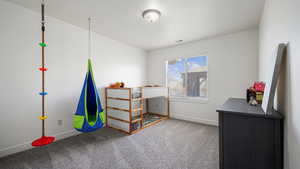 Carpeted bedroom with baseboards