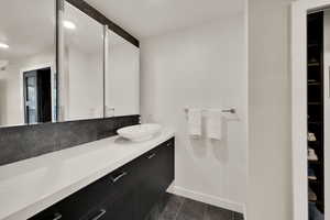 Bathroom featuring vanity and baseboards