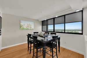 Dining space featuring light wood-type flooring, baseboards, and recessed lighting