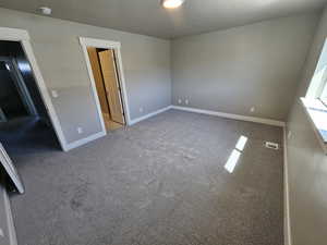 Unfurnished bedroom with carpet and baseboards