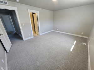 Unfurnished bedroom with carpet and baseboards