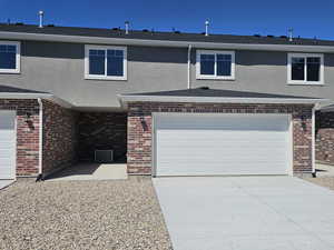 View of front of house with driveway and brick siding