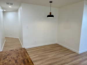 Unfurnished dining area with baseboards, light wood-style flooring, and recessed lighting