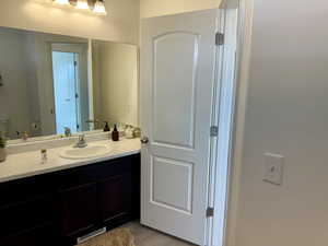 Bathroom with vanity and wood finished floors