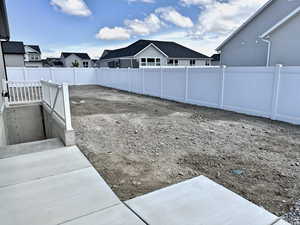 Fenced backyard with a residential view