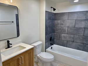 Bathroom with toilet, vanity, and shower / bathtub combination