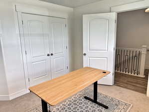 Home office featuring carpet floors and baseboards