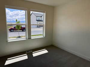 Empty room with carpet floors and baseboards