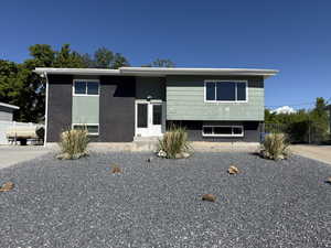 Raised ranch featuring fence and brick siding