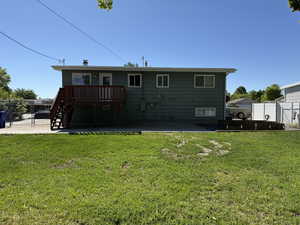 Rear view of property featuring a deck, stairway, and a patio