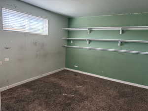 Spare room with carpet and baseboards