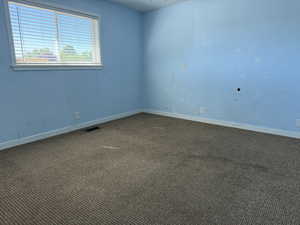Unfurnished room with carpet and baseboards