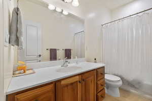 Full bath with toilet, tile floors, a shower and vanity